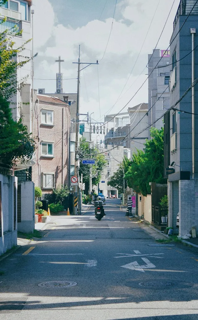 Low-rise residential buildings on a narrow street in Seoul